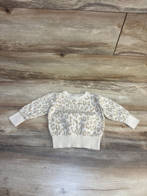 Cream leopard print kids sweater on wood floor, cozy long sleeve top for toddlers