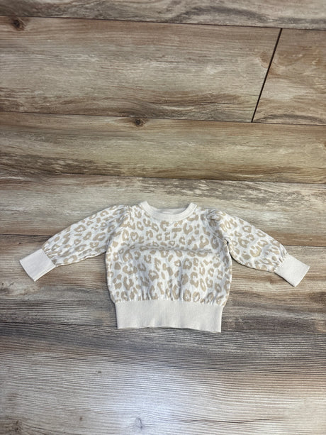 Cream leopard print kids sweater on wood floor, cozy long sleeve top for toddlers