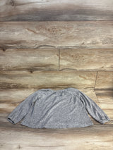 Gray long sleeve kids shirt laid flat on wood floor, ideal for resale clothing