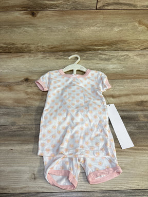 Front flat lay of Milkberry 2-piece bamboo baby pajama set (12 months) showcasing peach daisy print and pink trim on wood floor background