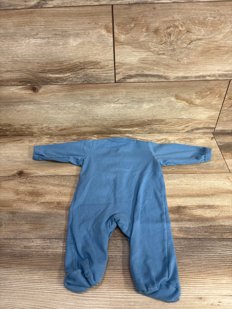Blue long-sleeve baby footed pajamas laid flat on wooden floor background