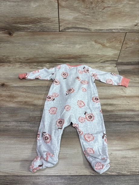 Grey Carter's baby sleeper with pink floral print and orange trim on a wood background