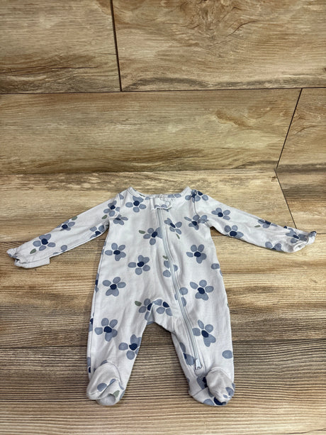 Front view of a Just One You blue floral newborn sleeper showcasing a full-length zipper and covered feet on a wood floor