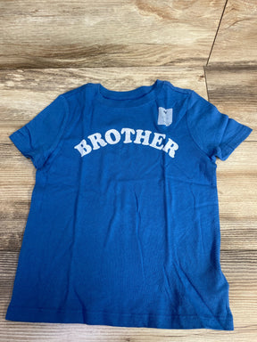 Blue kids t-shirt with 'BROTHER' text on wood background