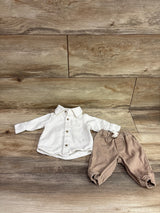 Flat lay of Just One You newborn corduroy shirt and pants set, showcasing a collared button-up shirt and elastic-cuff pants on wood