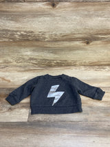 Dark gray toddler sweatshirt with silver lightning bolt graphic on wood floor background