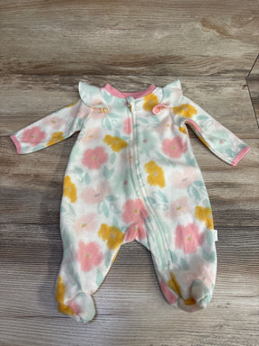 Floral baby fleece footed sleeper with pastel pink, yellow, and green flowers and pink trim on wooden floor