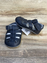 Front and side view of Just One You navy fisherman sandals size 4/5C 12-18M, woven toe straps and velcro tab on wood background