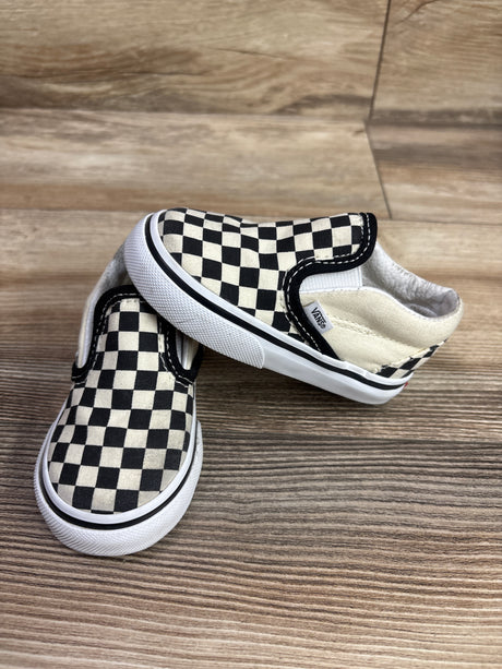 Top and side view of Vans Classic Slip-On Checkerboard Sneakers with white soles on wood