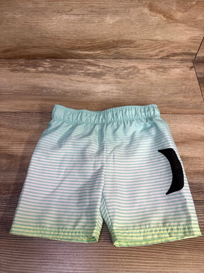 Front view of boys' Hurley swim trunks with light blue-and-white stripes, elastic waist, and black logo on wood background