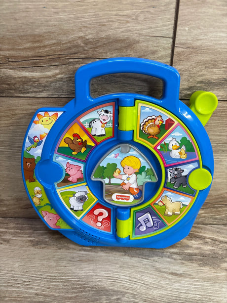Front view of blue Fisher-Price See 'n Say toy with animal picture panels, rotating dial and handle on wood background