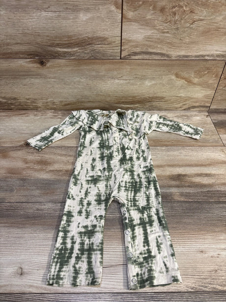 Flat-lay front of Beechwood Modal coverall, green tie-dye on ivory with ruffle collar and snap leg closures on wood