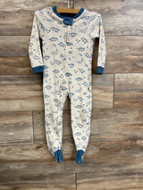 Front of beige Wonderluxe footed sleeper with blue dinosaur print, zip front, blue trim and gripper soles