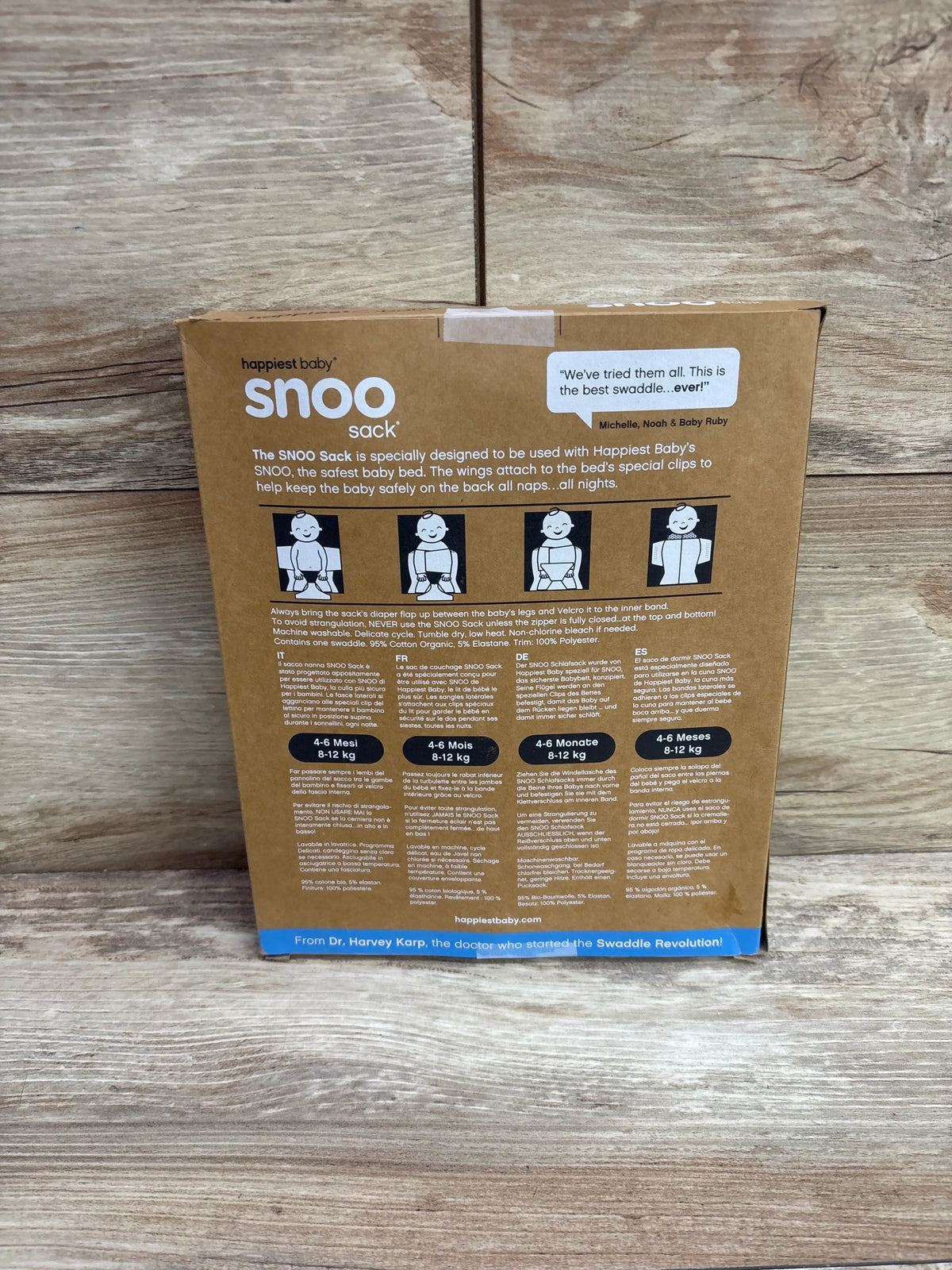 Back view of Happiest Baby SNOO sleep sack packaging showcasing safe-use diagrams and 4 to 6 month sizing on a wood surface