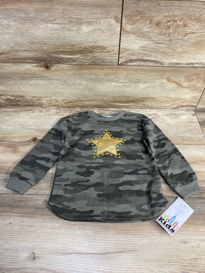 Kids camouflage long sleeve shirt with gold star and yellow studs on wooden background