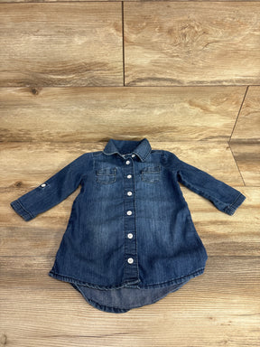 Long sleeve denim button-down toddler dress with chest pockets on wood background