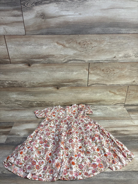 Laid-flat of girls' ivory short-sleeve tiered swing dress with pink-orange floral print, size 5T, on light wood background