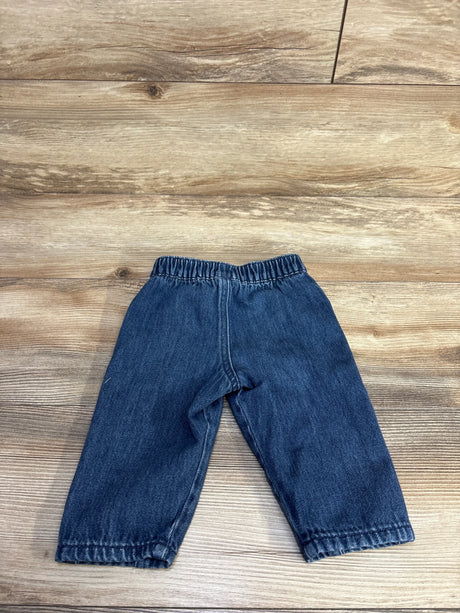 Front view of Easy Peasy pull-on baby jeans (12 months) showing elastic waistband and straight legs on wood background