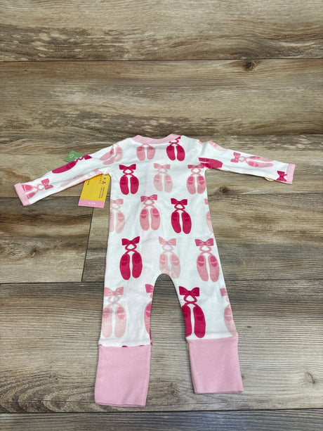 Flat lay of a white ballerina convertible sleeper showcasing pink ballet slipper print and pink cuffs on a wood background