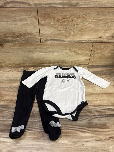 Front view of white NFL Raiders girl bodysuit and black footed pants set showcasing black trim and foot bows on wood flooring