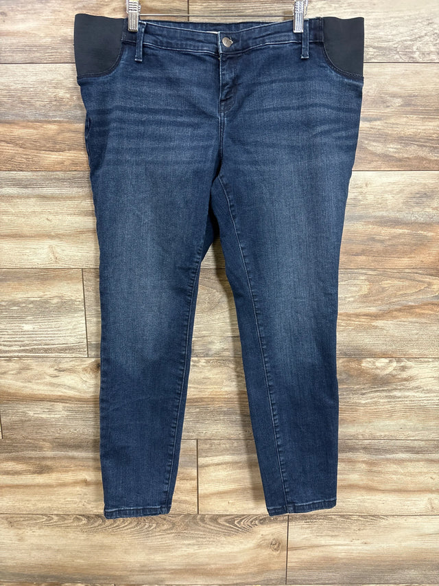 Flat lay of Isabel Maternity side panel skinny jeans in dark wash blue with black elastic side panels on wood plank floor