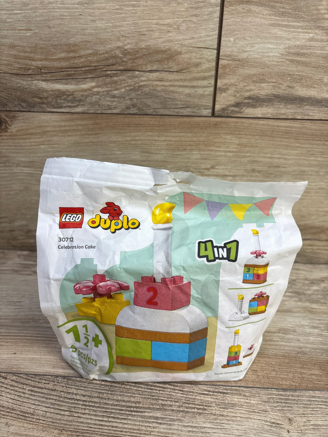 Front view of LEGO DUPLO Celebration Cake showcasing cake with candle and 4-in-1 build options on wood floor