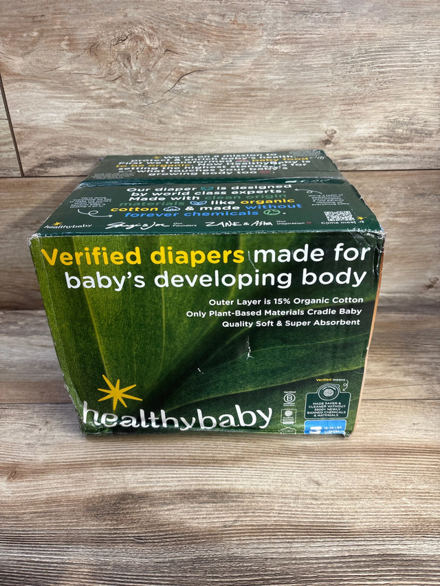 Front view of Healthybaby size 3 diaper box (56 ct) showing headline Verified diapers made for baby's developing body and 15% organic cotton claim on a wooden tabletop