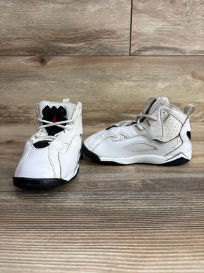 Pair of white and black toddler Jordan sneakers on wooden surface, kids resale shoes