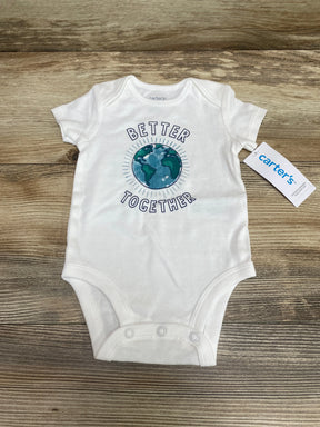 Flat lay of white Carter's bodysuit with earth graphic and BETTER TOGETHER text, tag on wood background