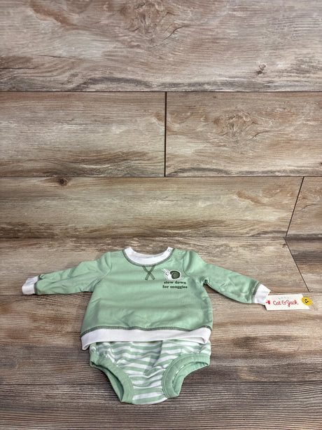 Mint green baby onesie with white striped bottom and snail graphic, laid on wood floor