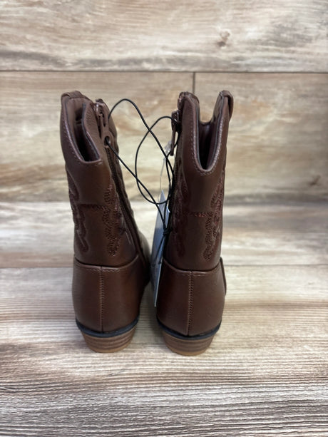 Rear view of Cat and Jack Memphis western boots showcasing embroidered shafts and stacked heels on a wood-look background