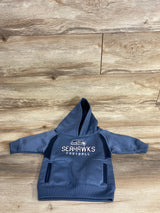 Toddler-sized blue Seahawks football hoodie with front pockets on wooden floor