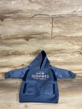 Toddler-sized blue Seahawks football hoodie with front pockets on wooden floor
