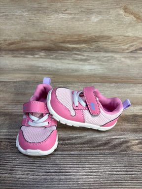 Three-quarter view of pink See Kai Run Tenny toddler sneakers showing mesh upper, velcro strap, elastic laces on wood