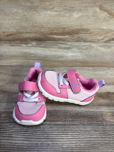 Three-quarter view of pink See Kai Run Tenny toddler sneakers showing mesh upper, velcro strap, elastic laces on wood