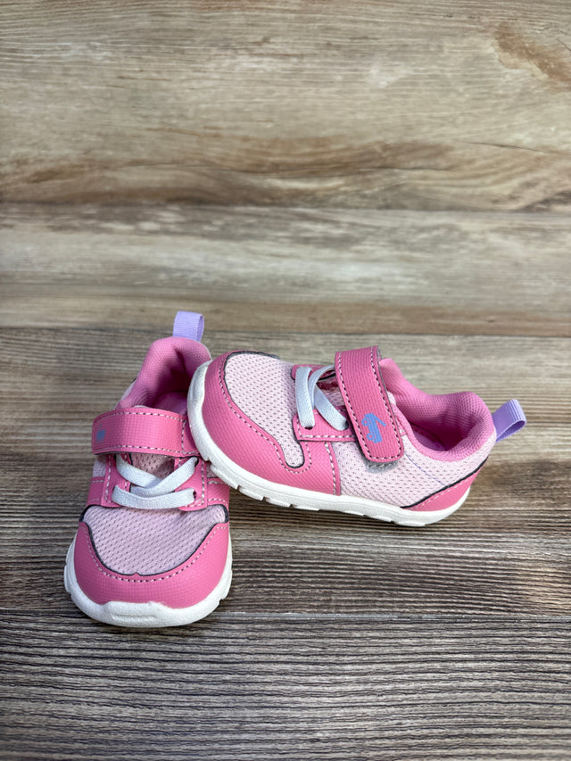 Three-quarter view of pink See Kai Run Tenny toddler sneakers showing mesh upper, velcro strap, elastic laces on wood