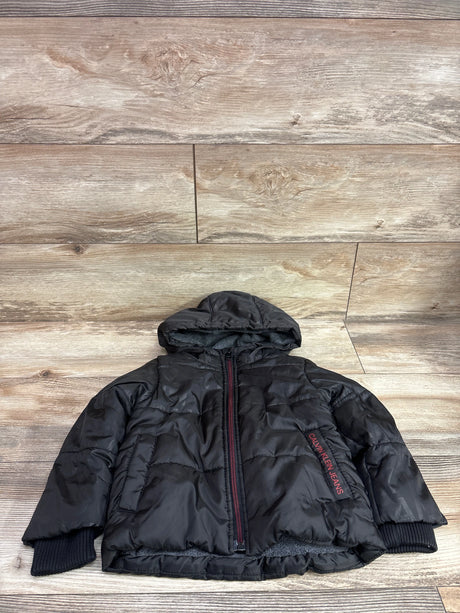 Front view of black Calvin Klein Jeans puffer jacket, size 2T, with hood, quilted padding, front zipper, and ribbed cuffs