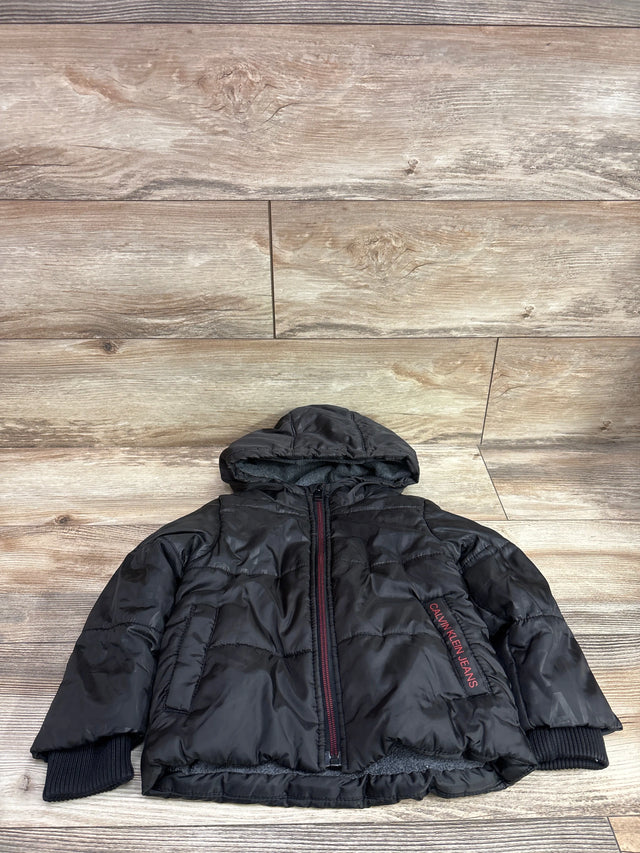 Front view of black Calvin Klein Jeans puffer jacket, size 2T, with hood, quilted padding, front zipper, and ribbed cuffs