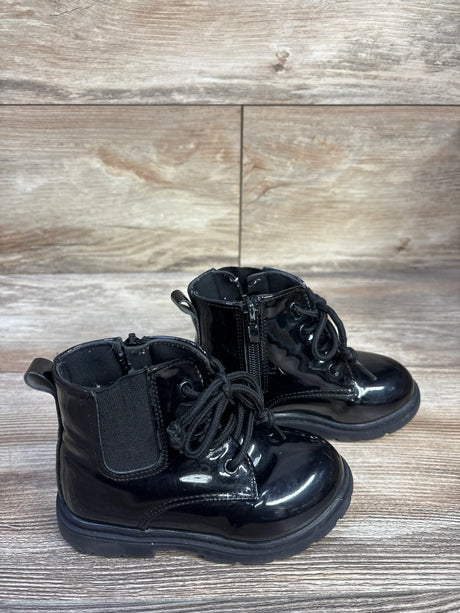 Three-quarter view of kids’ black faux-leather lace-up boots showing laces, stitched sole, and round toe on white background