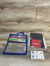 Children's vocabulary language learning kit with flashcards and activity pack on wood background