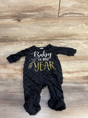 Black baby romper with 'Baby of the Year' gold and white text on wood floor