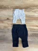 White and navy baby pants on wood floor, soft cotton infant leggings for newborns and toddlers