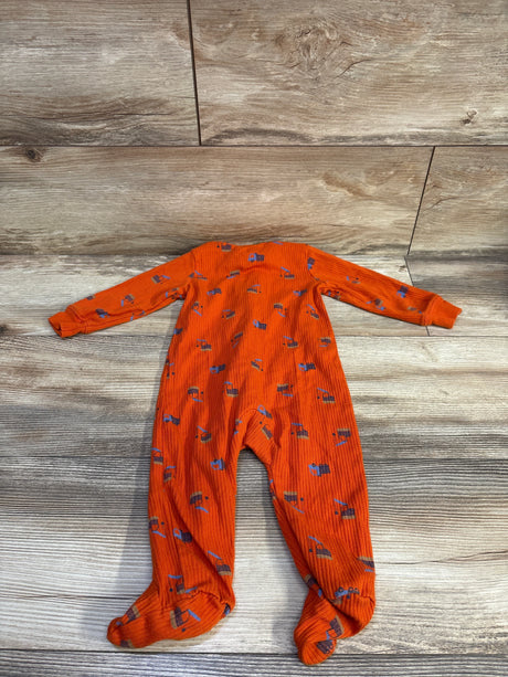Flat lay of Carter’s orange ribbed footed sleeper, size 9 months, showing ribbed texture, long sleeves, and small print on wood background