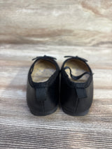 Rear view of Cat & Jack Nora black toddler slip-on ballet flats (6C) showing heel tabs and elastic collar on wood background