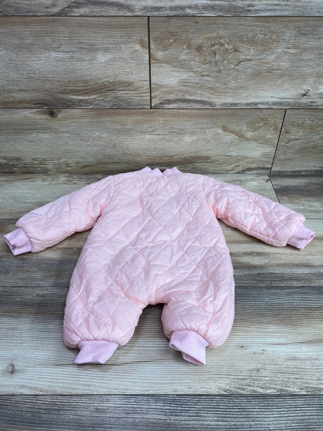 Flat lay of pink quilted coverall in size 3 months showcasing ribbed cuffs and ankle bands on wood-look flooring