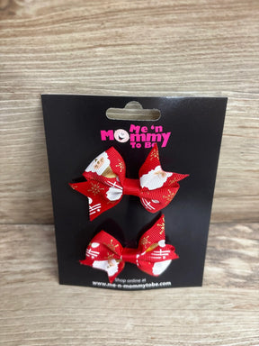 Red Santa-themed hair bows with gold accents for kids, festive holiday accessory