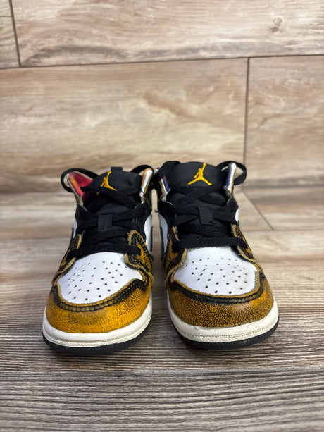 Front view of toddler Air Jordan 1 Mid SE Wear-Away Taxi sneakers, size 8C showcasing worn yellow overlays and black tongues on wood floor