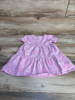 Flat lay of pink Gap Kids toddler dress with white butterfly print, short ruffle sleeves and tiered skirt on wood floor