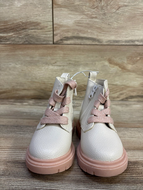 Front view of Cat & Jack Amaya toddler zipper combat boots showing cream textured upper, pink chunky sole and pink laces on wooden background