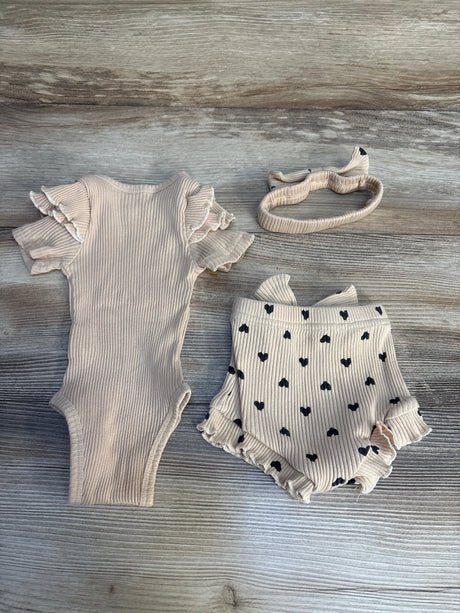 Neutral ribbed baby bodysuit with ruffle sleeves, matching polka dot shorts, and headband set